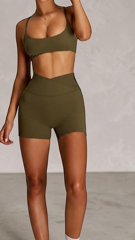 SOLID APPRL olive green athletic shorts with high-waisted crossover waistband, perfect for workouts.