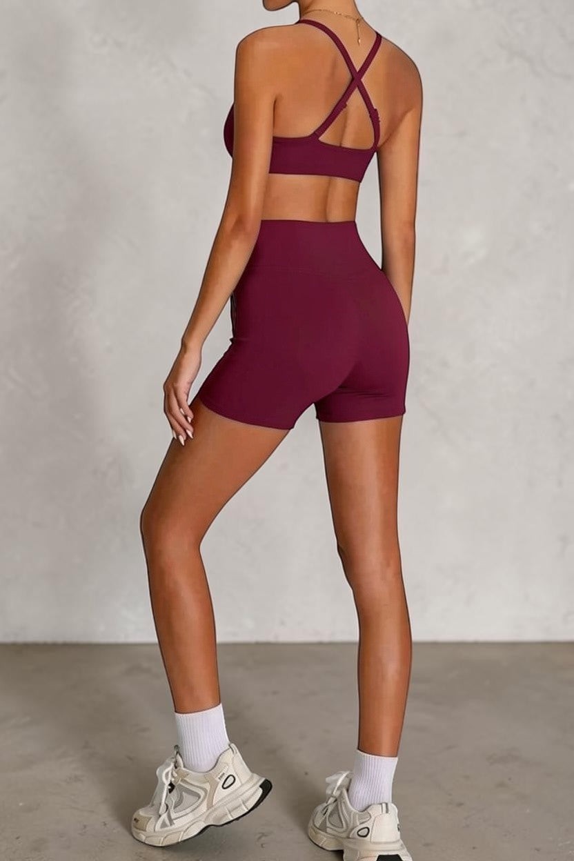 SOLID APPRL burgundy athletic high-waisted crossover shorts with a matching sports bra, designed for performance and comfort.
