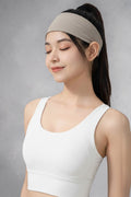Woman wearing a beige SOLID APPRL moisture-wicking athletic headband with a yellow t-shirt for fitness training.