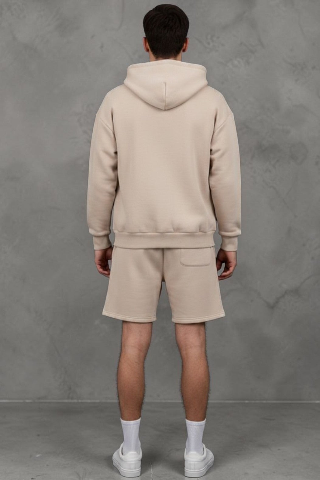 Model wearing a beige SOLID APPRL heavyweight zip-up hoodie and matching shorts with a white t-shirt and sneakers.