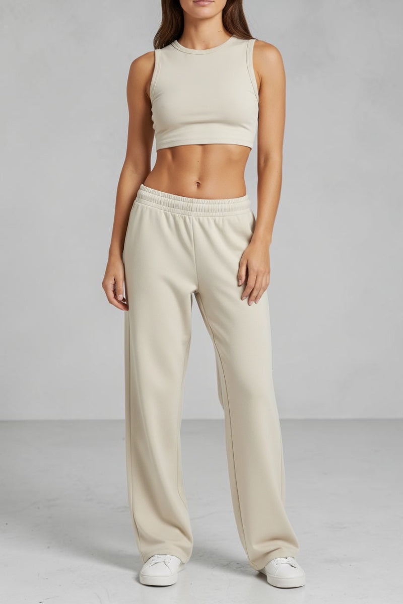 SOLID APPRL unisex relaxed fit lounge pants in beige with an elastic waistband, worn by a model on a white background.