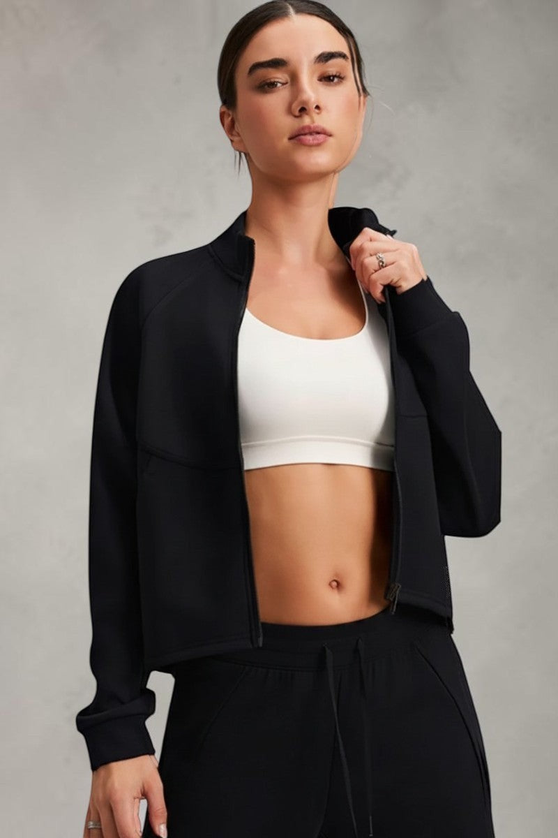 SOLID APPRL black athletic zip-up track jacket with high neck and raglan sleeves, cropped silhouette.