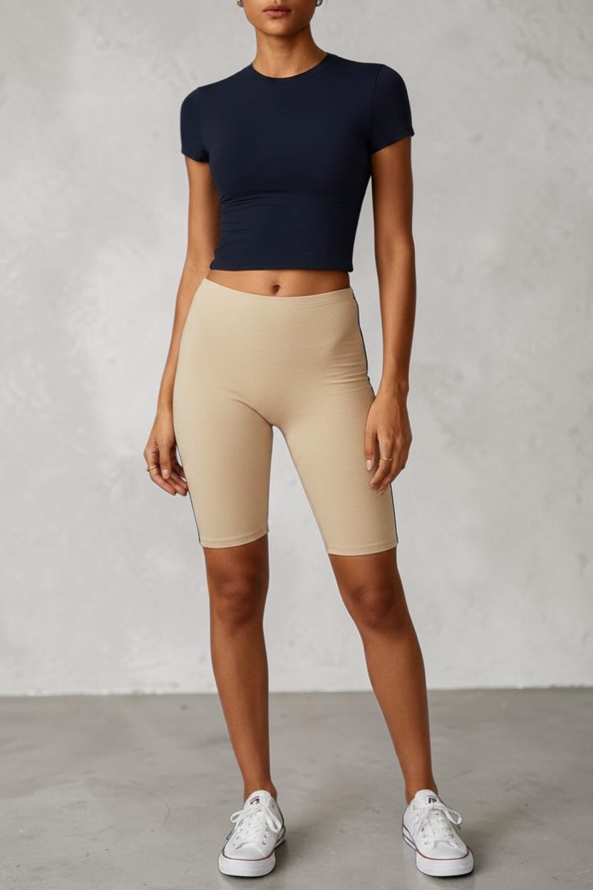 Model wearing a SOLID APPRL black short sleeve crew neck crop top in a soft, stretchy, form-fitting fabric.