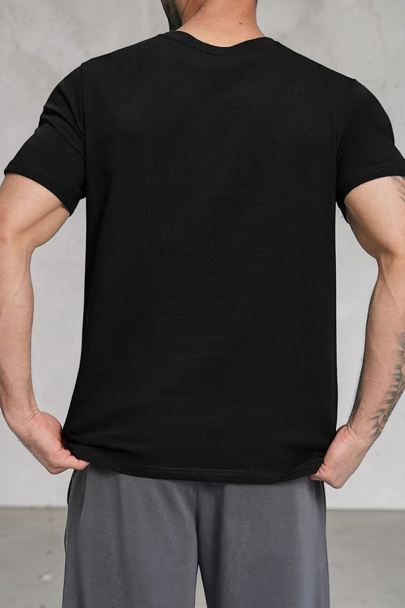 Back view of a man wearing a SOLID APPRL black crew neck short sleeve t-shirt with a classic fit.