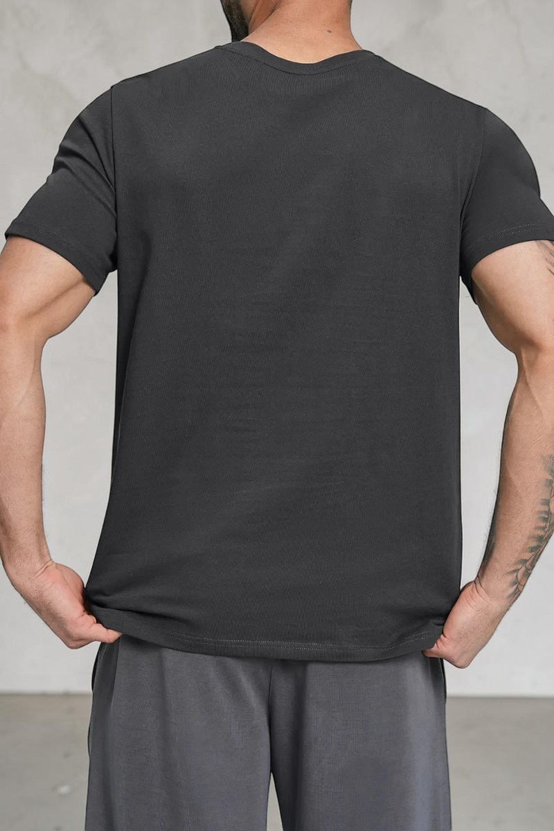 Back view of a man wearing a SOLID APPRL black crew neck short sleeve t-shirt with a classic fit.