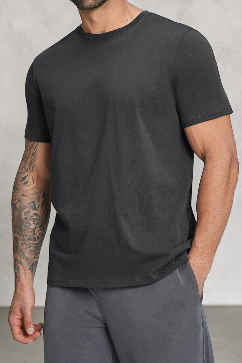 SOLID APPRL black crew neck short sleeve t-shirt worn by a tattooed man on a neutral background.