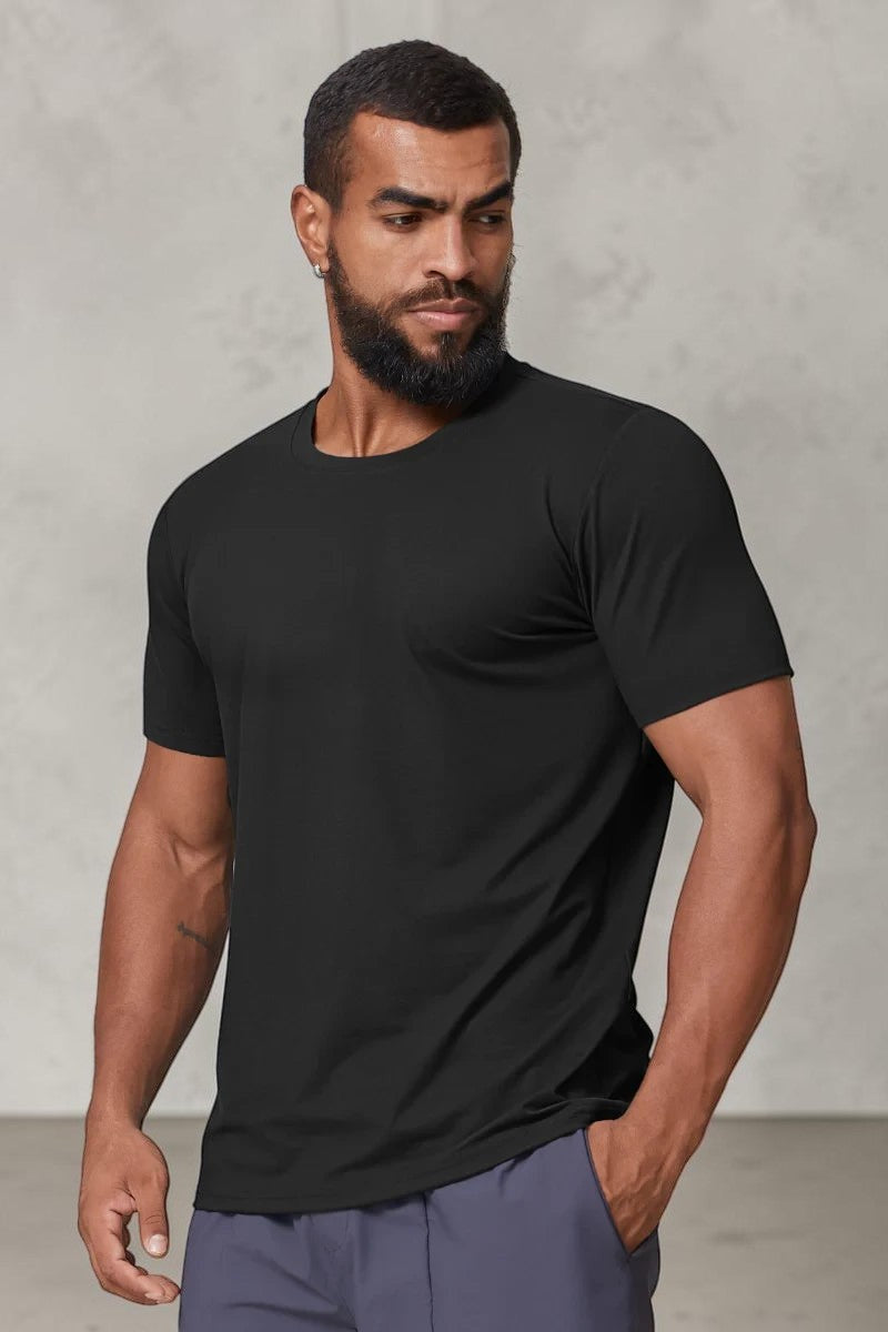 SOLID APPRL black performance crew neck t-shirt on a muscular model, featuring moisture-wicking athletic fabric.