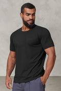 SOLID APPRL black performance crew neck t-shirt on a muscular model, featuring moisture-wicking athletic fabric.