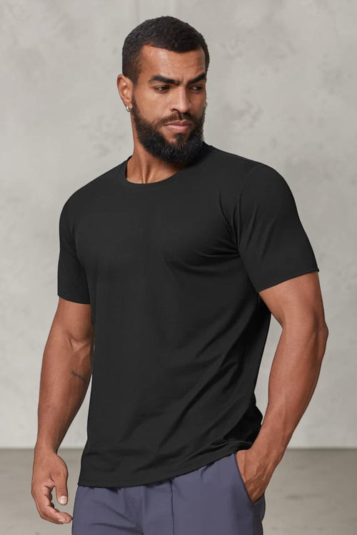 SOLID APPRL black performance crew neck t-shirt on a muscular model, featuring moisture-wicking athletic fabric.