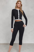 Model wearing a SOLID APPRL black and white color-blocked long sleeve button-up crop top with contrast trim.