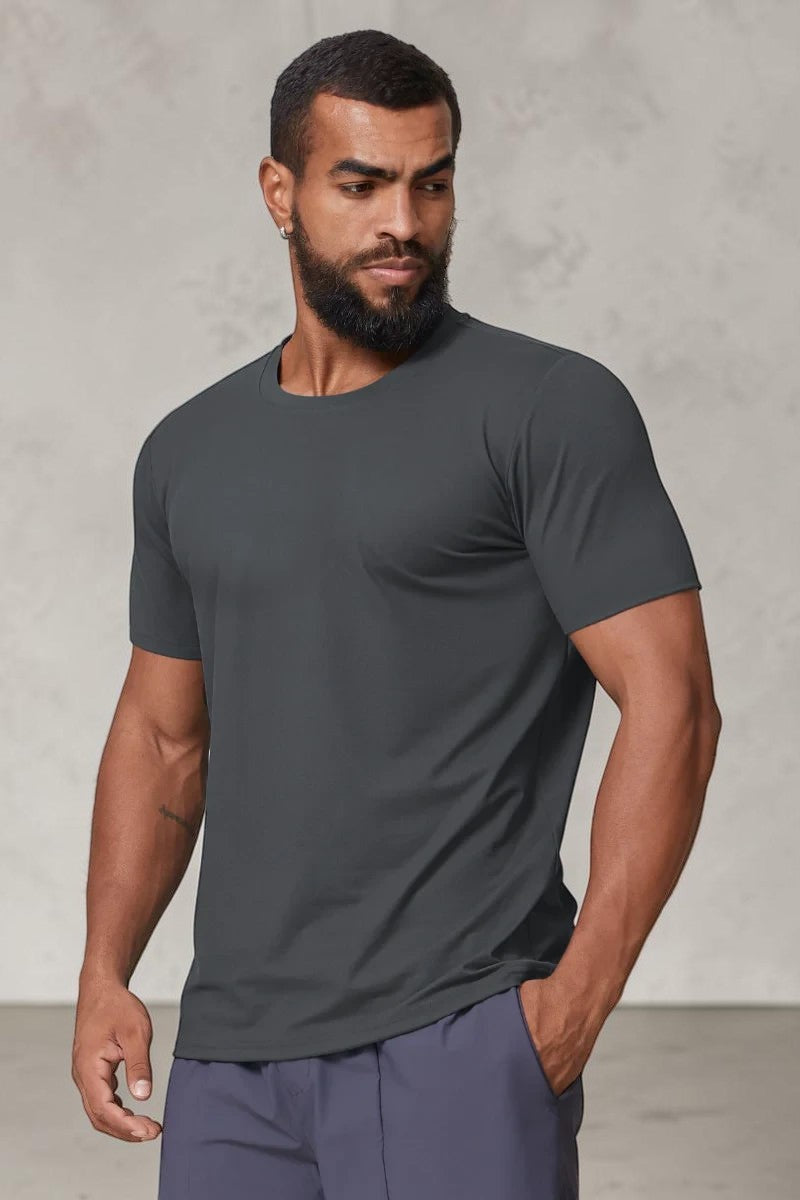 SOLID APPRL charcoal grey performance crew neck t-shirt with an athletic fit worn by a man against a plain background.