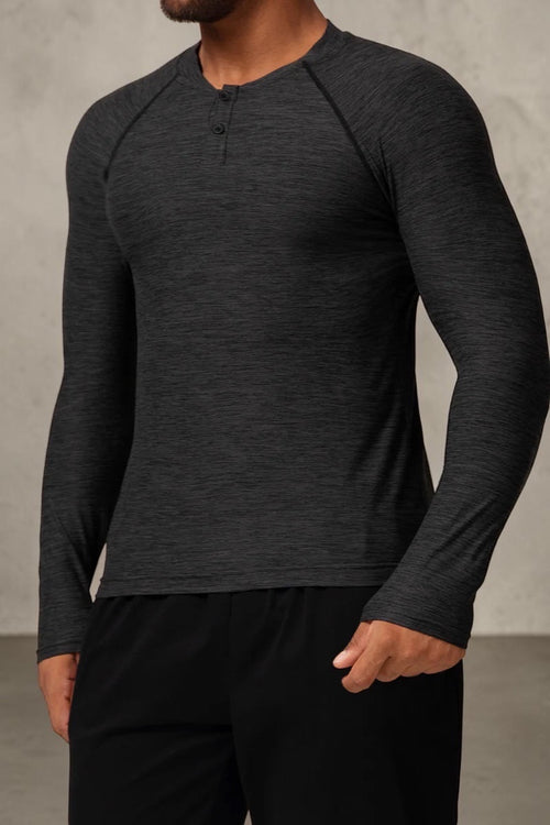 SOLID APPRL charcoal heathered long sleeve performance henley shirt with raglan sleeves on a male model.