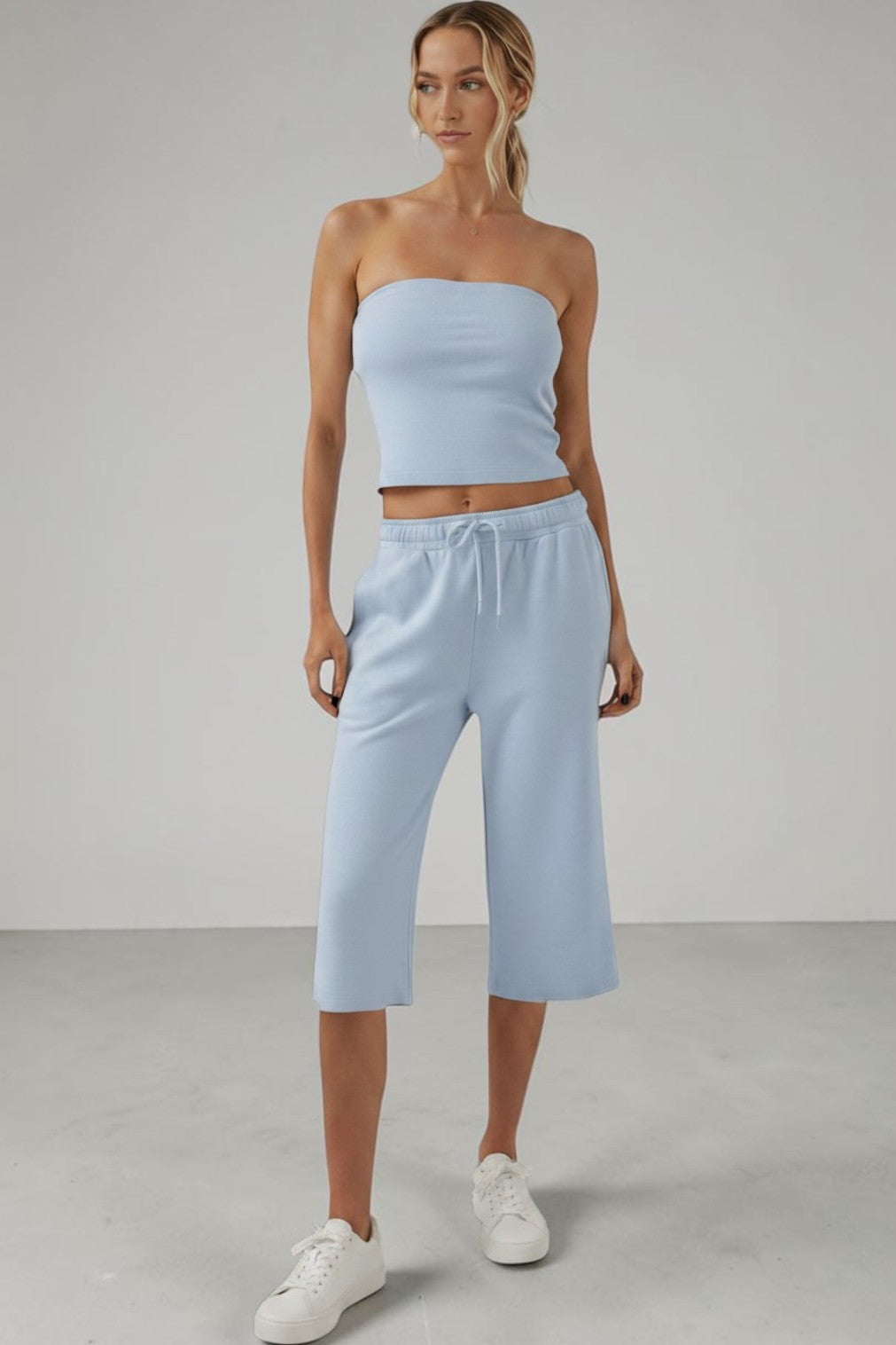 Model wearing a SOLID APPRL cream ribbed tube top and matching cropped sweat jorts with an elastic drawstring waist.