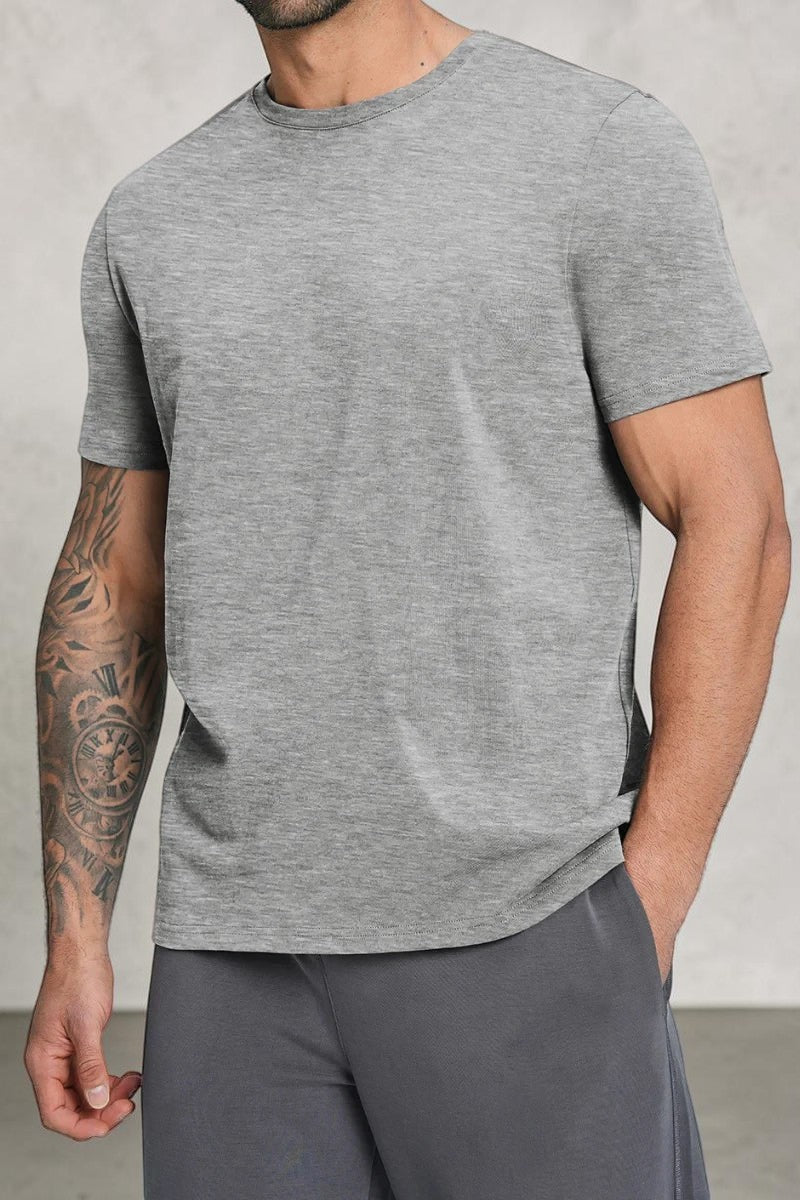 SOLID APPRL grey crew neck short sleeve t-shirt on a muscular man with arm tattoos, soft breathable fabric.