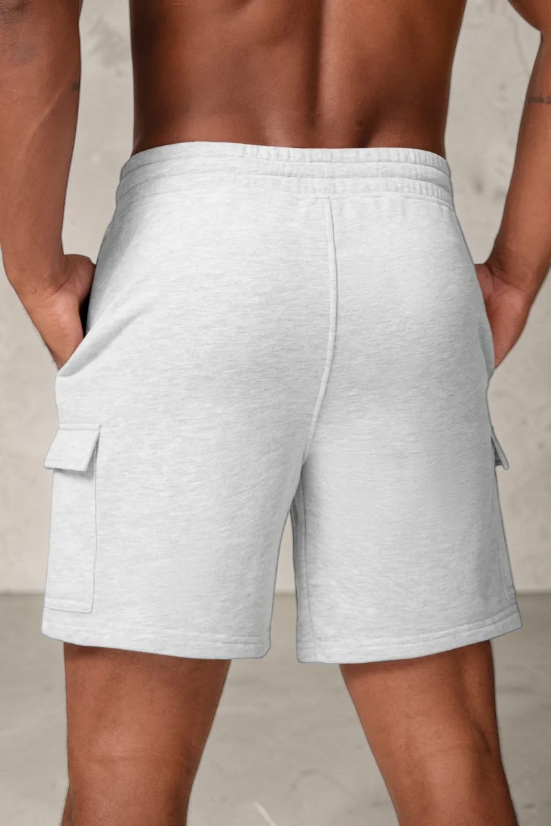 Back view of SOLID APPRL light grey fleece cargo shorts with side pockets and elastic drawstring waistband on a model