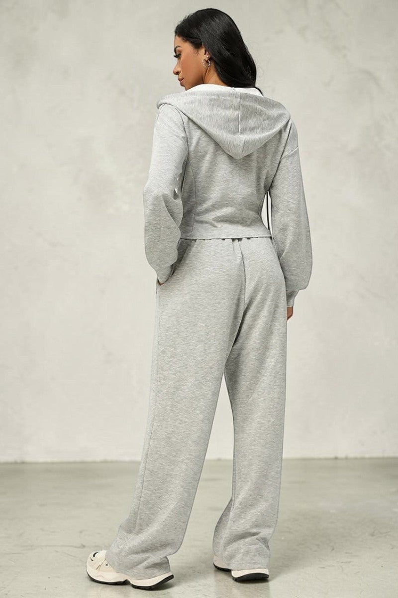 Model wearing a SOLID APPRL grey zip-up hoodie and wide-leg lounge pants set in a soft, comfortable fabric.