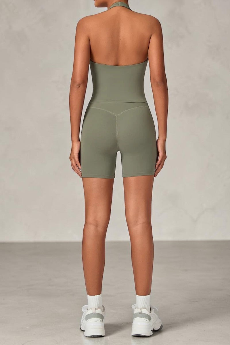 SOLID APPRL olive green halter neck tank top and high-waisted biker shorts set on a model from the back view.