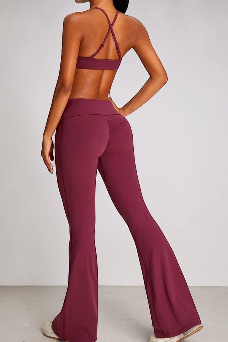 SOLID APPRL women's high-waisted flare yoga pants in deep berry, featuring ruched detailing and a stretchy, breathable fabric.