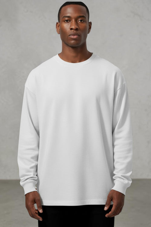 Model wearing a SOLID APPRL light grey long sleeve crewneck shirt with a relaxed fit and ribbed cuffs.