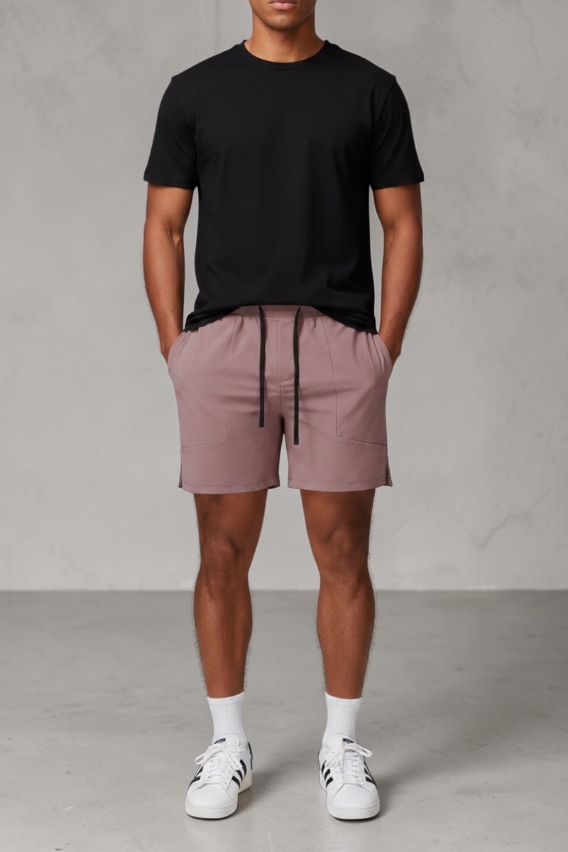 SOLID APPRL mauve performance athletic shorts with adjustable drawstring waistband and deep side pockets on a model.