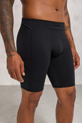 SOLID APPRL men's black compression training shorts with a high-rise waistband and side pockets on a fit model