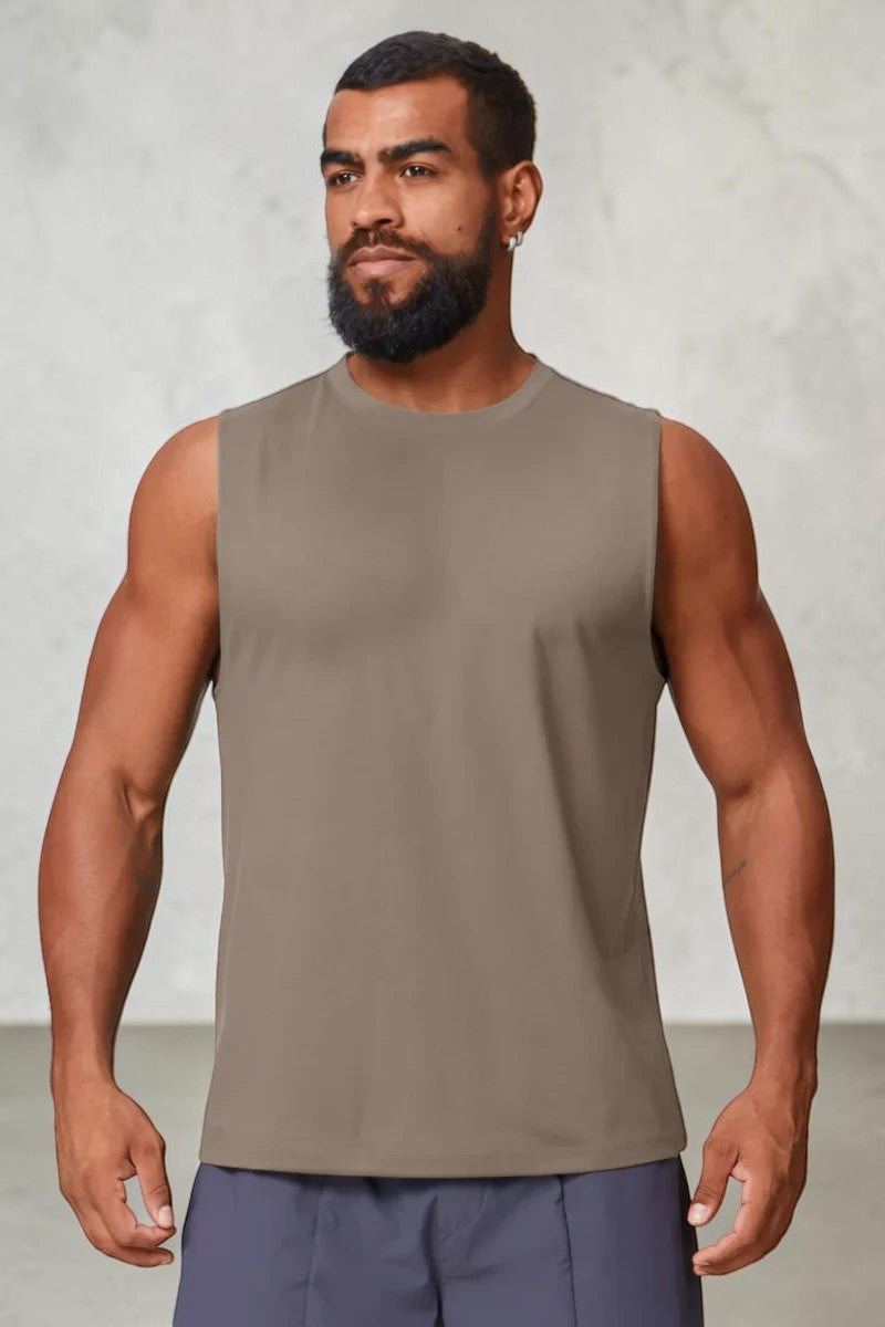 A man wearing a taupe SOLID APPRL performance sleeveless tank top with a crew neck for gym and athletic training.