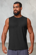 A man wearing a black SOLID APPRL performance tank top with a crew neckline, designed for gym workouts.