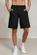 SOLID APPRL men's grey performance athletic training shorts with an elastic waistband and side pockets on a model.