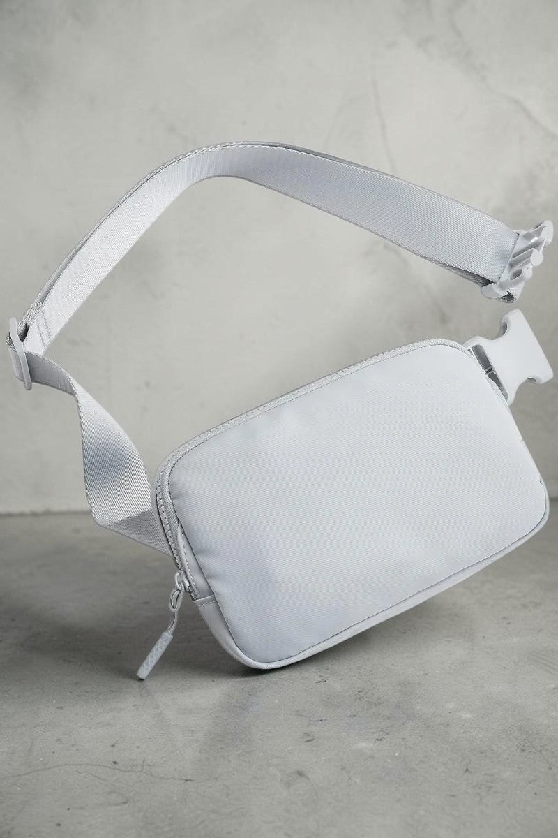 SOLID APPRL minimalist light grey belt bag with adjustable strap, secure zipper closure, and durable fabric.