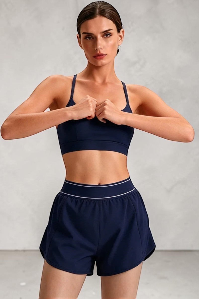 SOLID APPRL navy blue athletic sports bra and shorts set for women, breathable fabric, criss-cross back, elastic waistband.