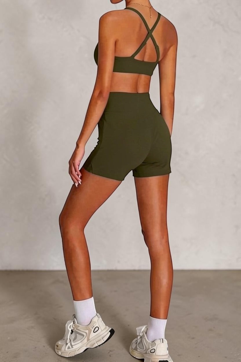 SOLID APPRL olive green athletic shorts with crossover waistband and matching sports bra with criss-cross straps.