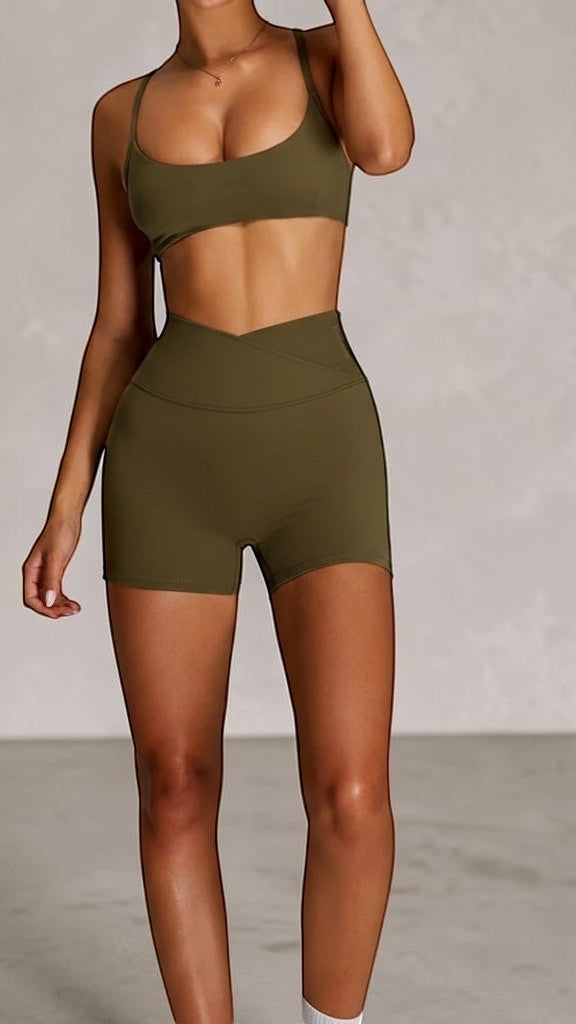 SOLID APPRL olive green high-waisted athletic shorts with crossover waistband and matching sports bra.