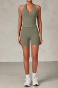 SOLID APPRL olive green halter neck tank top and high-waisted biker shorts activewear set on a model.