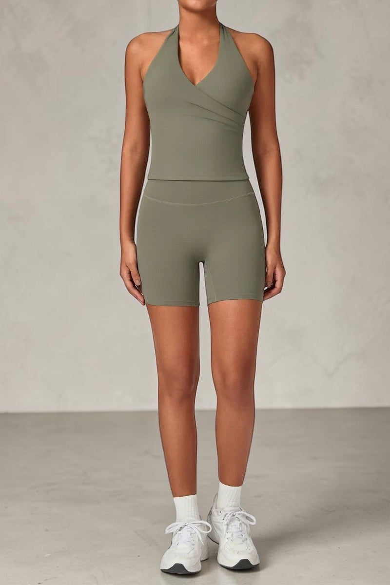 SOLID APPRL olive green halter neck tank top and high-waisted biker shorts activewear set on a model.
