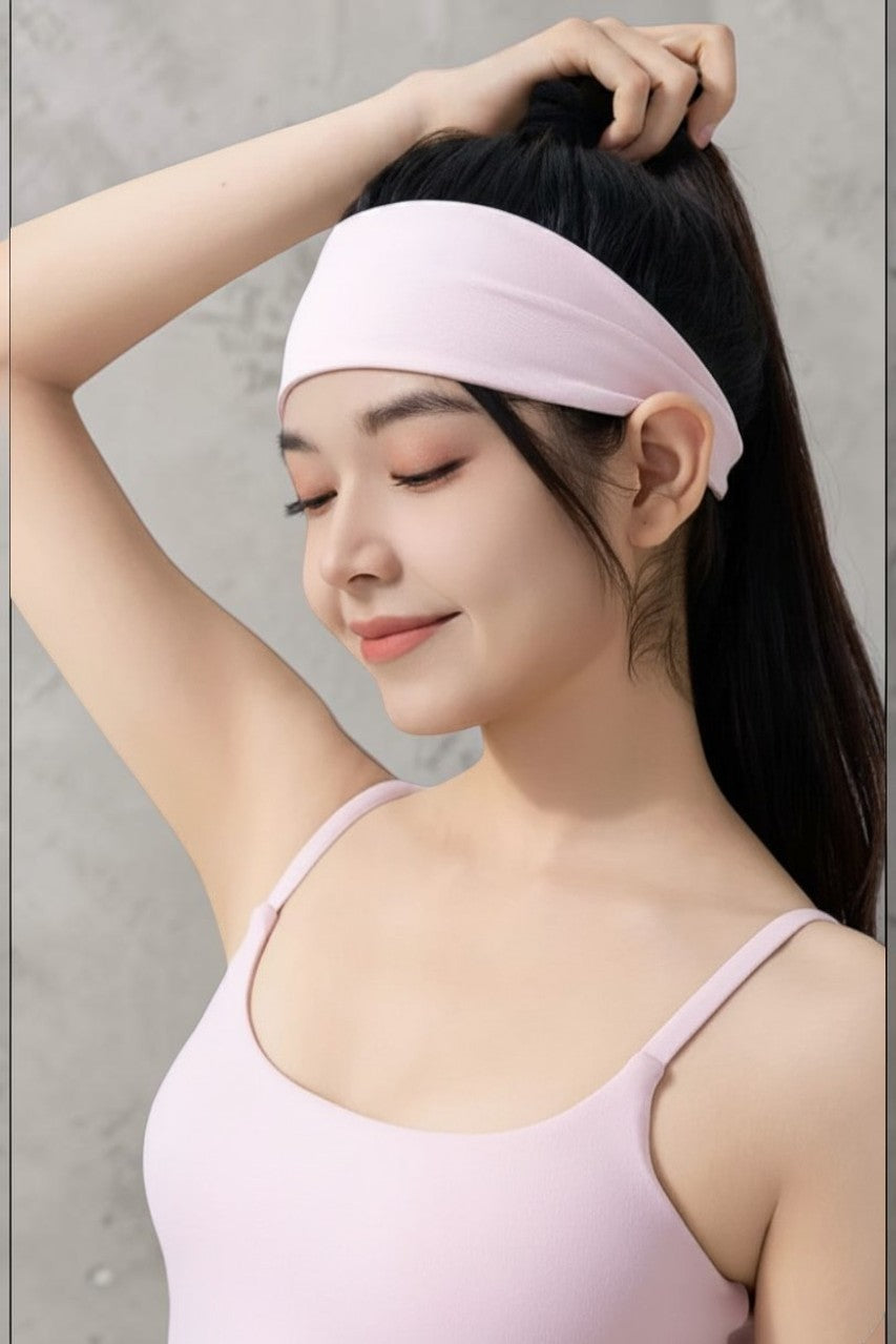 SOLID APPRL light pink moisture-wicking athletic headband worn by a woman in a matching workout tank top.