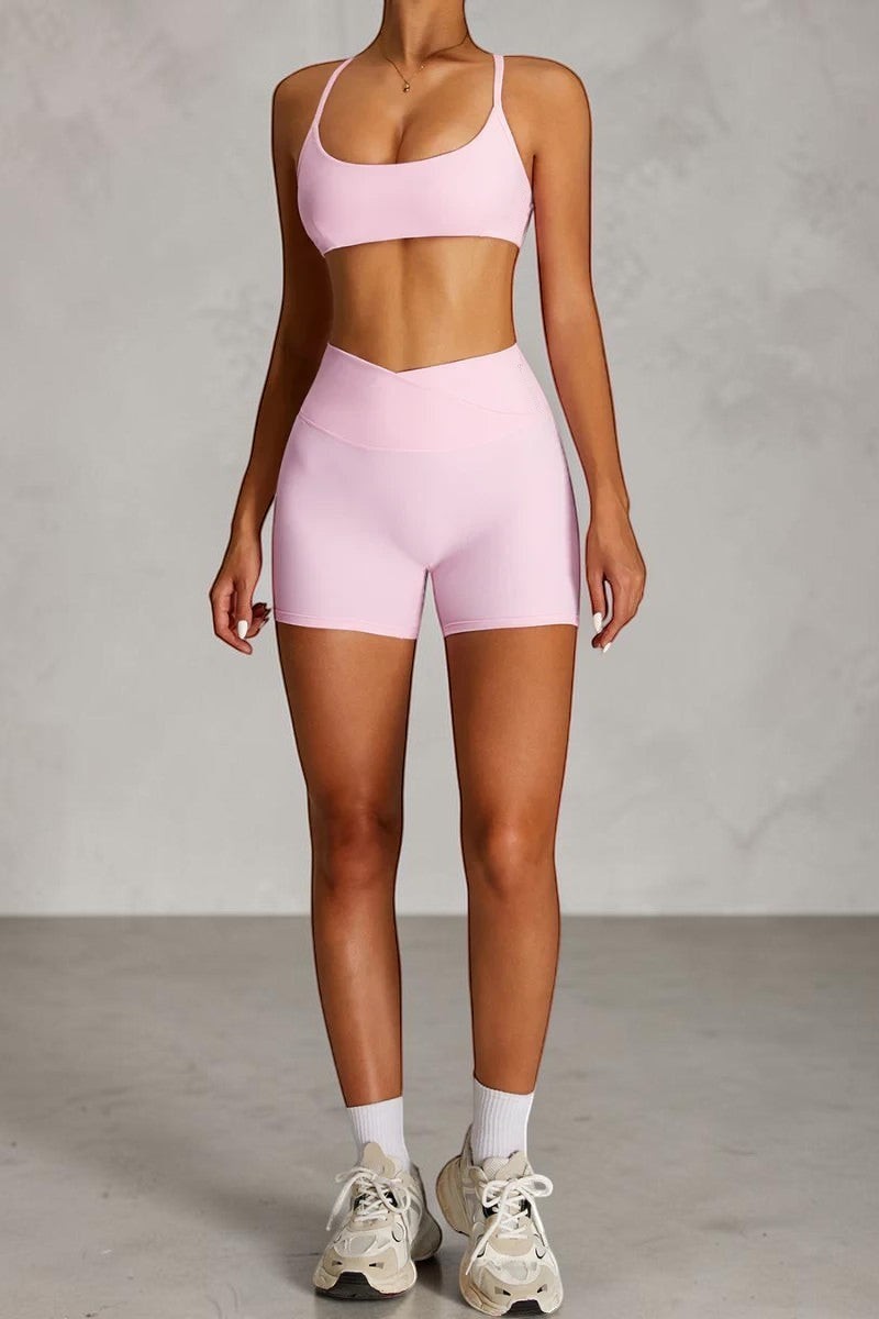 SOLID APPRL light pink athletic high-waisted crossover shorts with a matching sports bra.