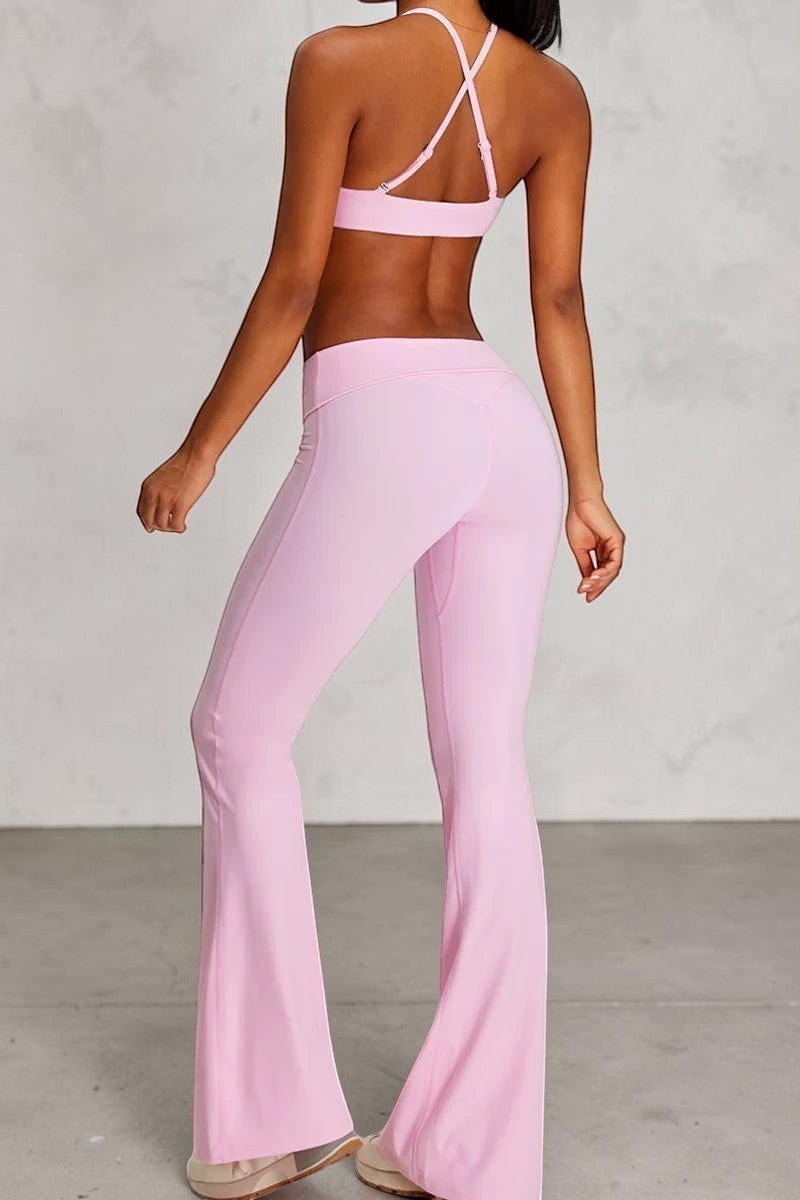 SOLID APPRL pastel pink high-waisted flare yoga pants made of stretchy, breathable fabric.