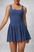 SOLID APPRL deep blue moisture-wicking athletic tennis dress with a square neckline and pleated skirt.