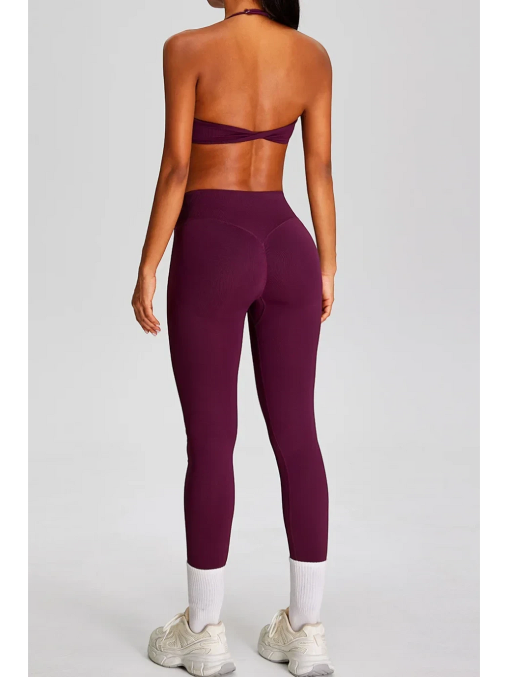 SOLID APPRL plum ribbed seamless high-waisted leggings with V-cut back detail and white socks.