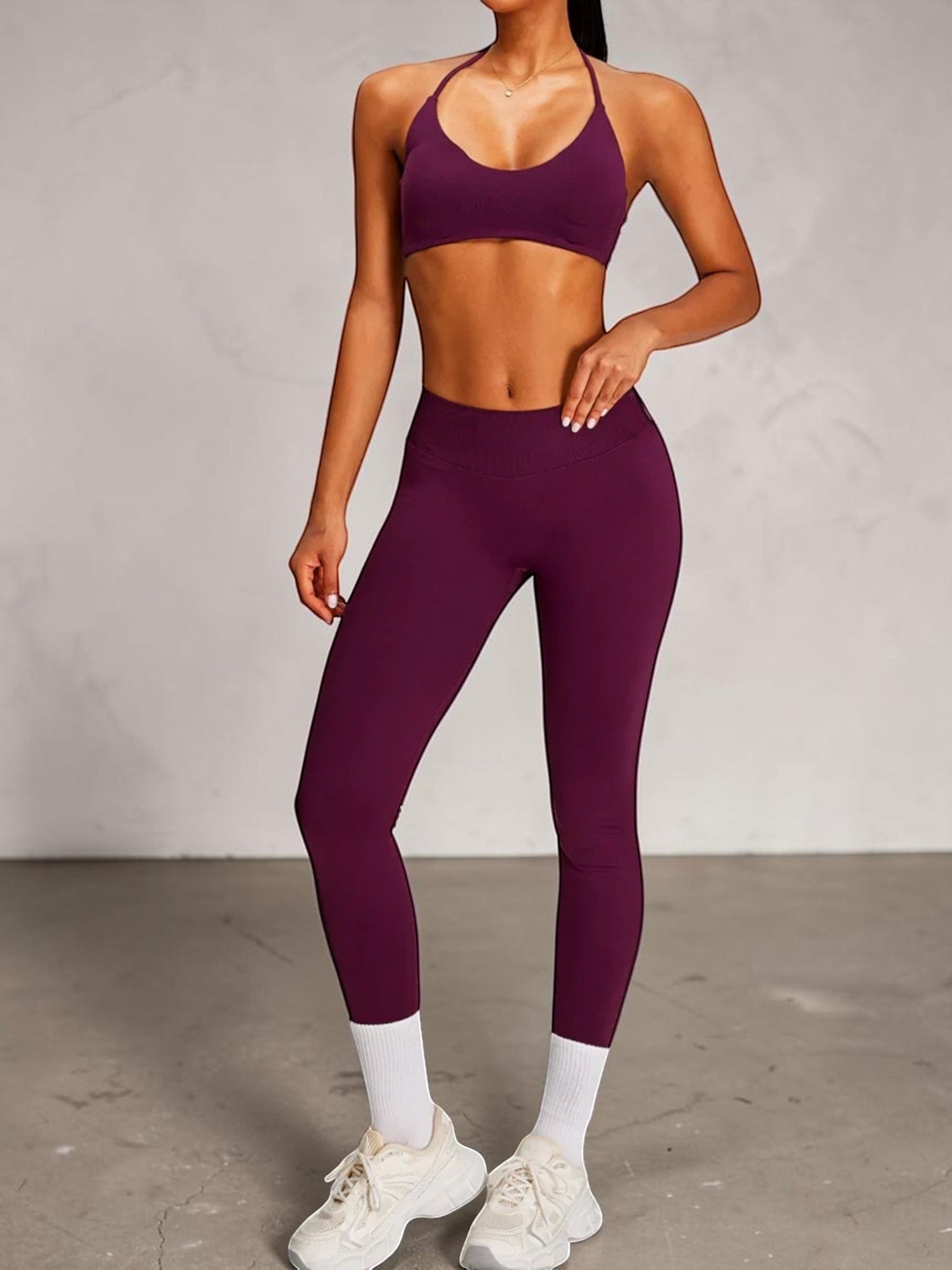 SOLID APPRL plum seamless ribbed high-waisted leggings with V-cut back detail and matching halter bra.