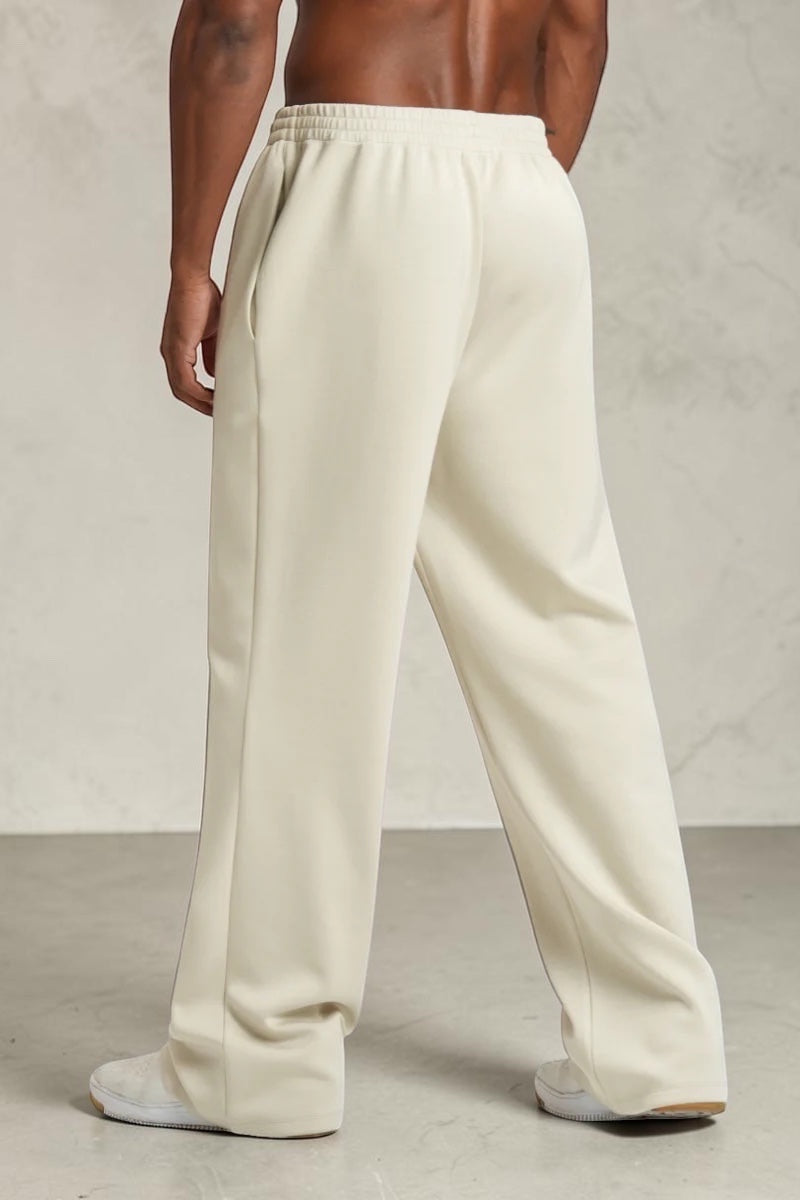 SOLID APPRL relaxed-fit cream sweatpants with an elastic waistband, worn by a model on a plain white background.