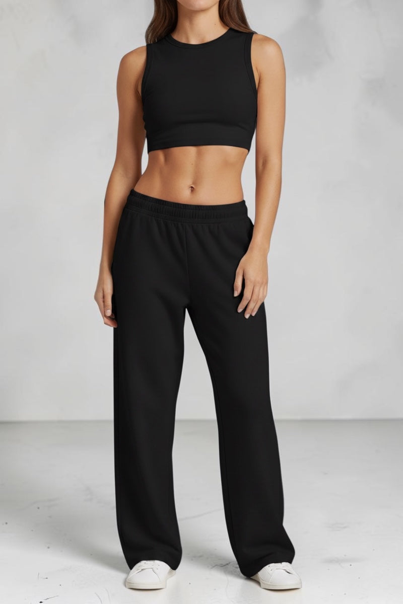 Model wearing SOLID APPRL beige relaxed fit lounge pants with an elastic waistband and matching crop top.