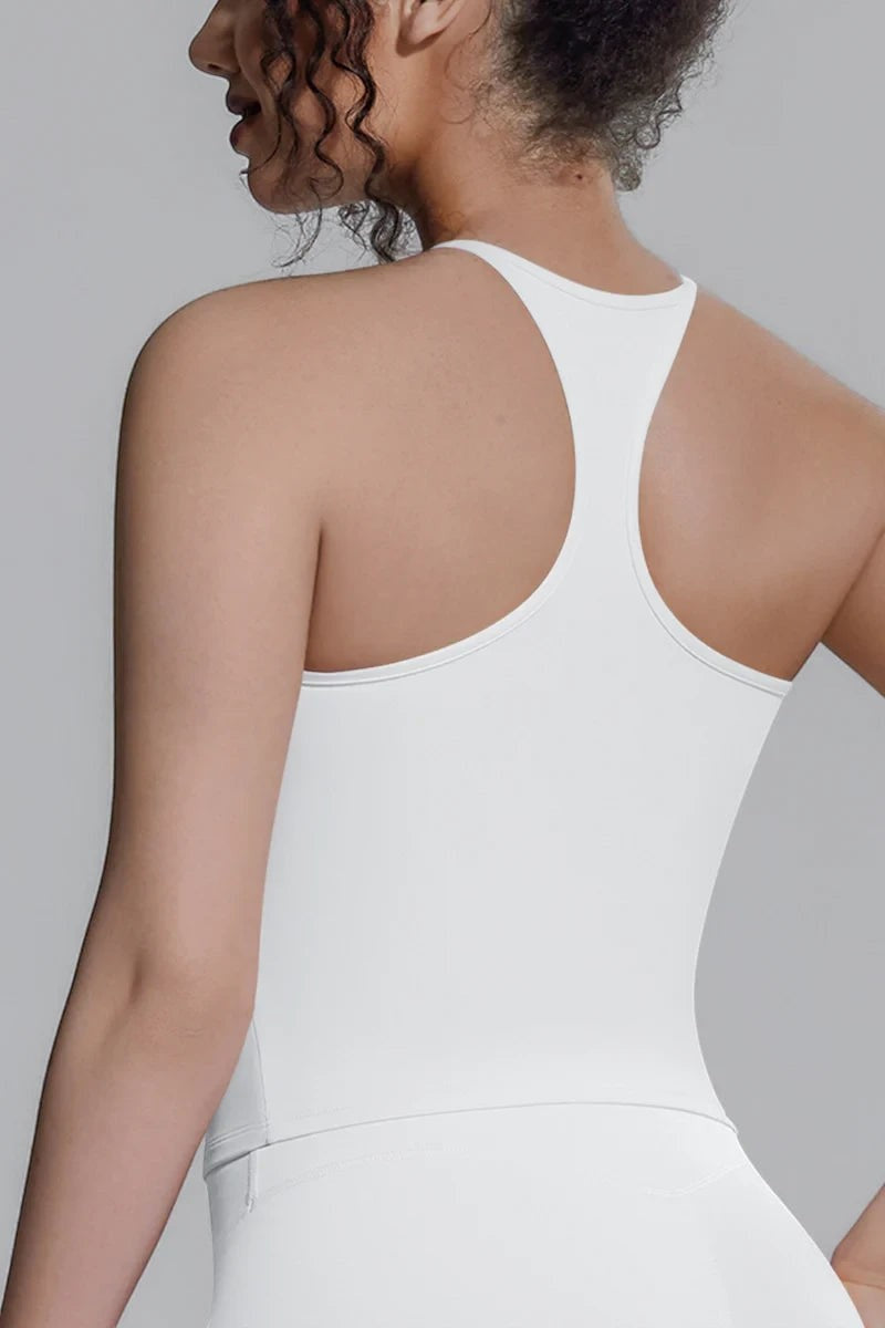 Model wearing a white SOLID APPRL moisture-wicking racerback tank top for athletic training and yoga.